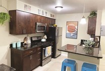 Granite kitchen counter space with stools.